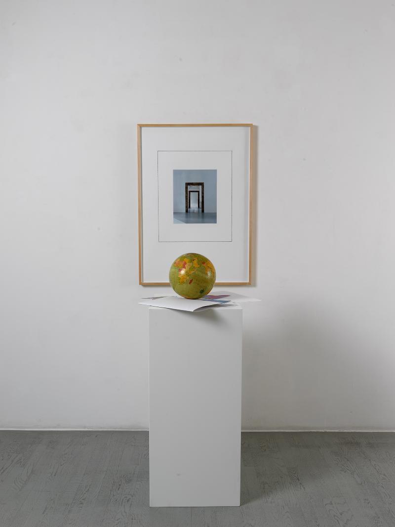 Fuori scena, 2024, framed collage, antique globe, white base collage 100 x 70 cm (unframed)  102 x 72,5 x 3,5 cm (framed); globe  24 cm, base 100 x 45 x 45 cm; h 202 x 72,5 x 90 cm overall dimensions 